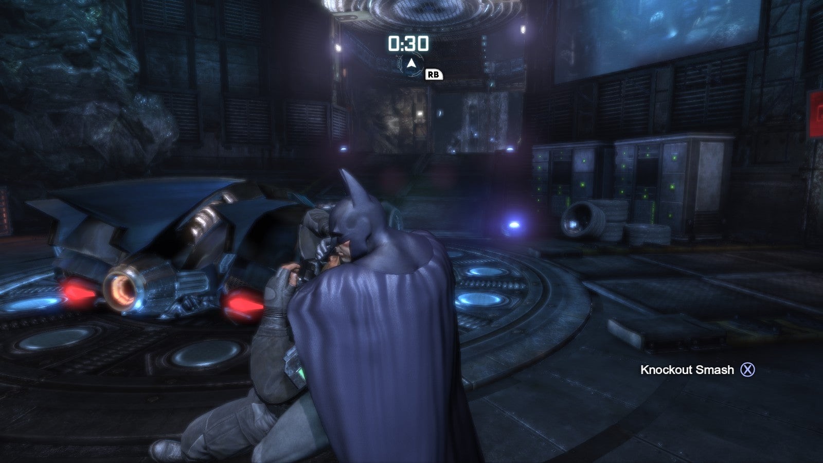 Batman bóp cổ một tay sai bên cạnh Batmobile trong Batcave từ Arkham City