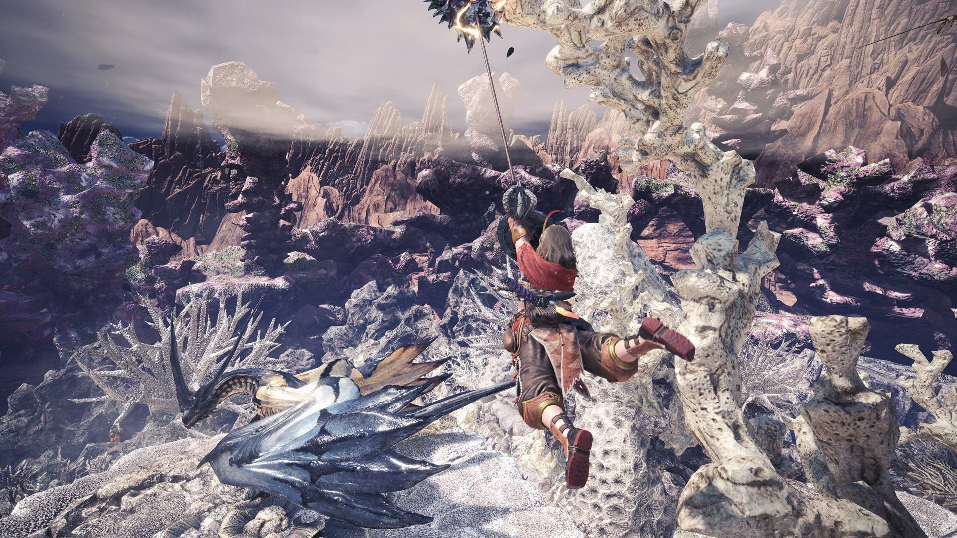 Một nữ thợ săn đu dây trên không trung phía trên một con quái vật rồng xanh trong Monster Hunter World