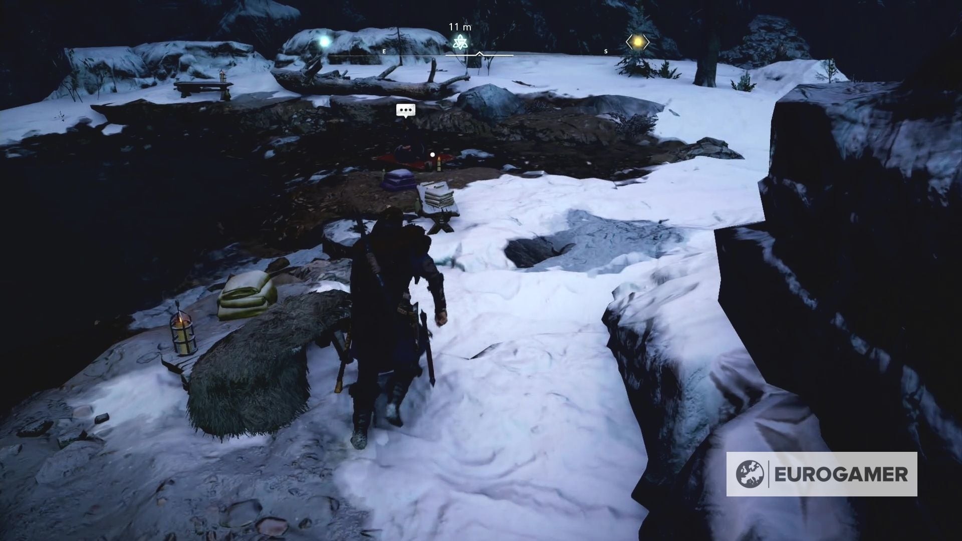 Nhân vật Bil ngồi bên bờ hồ trong Assassin's Creed Valhalla, chờ đợi người tìm lại chiếc lược bị mất.