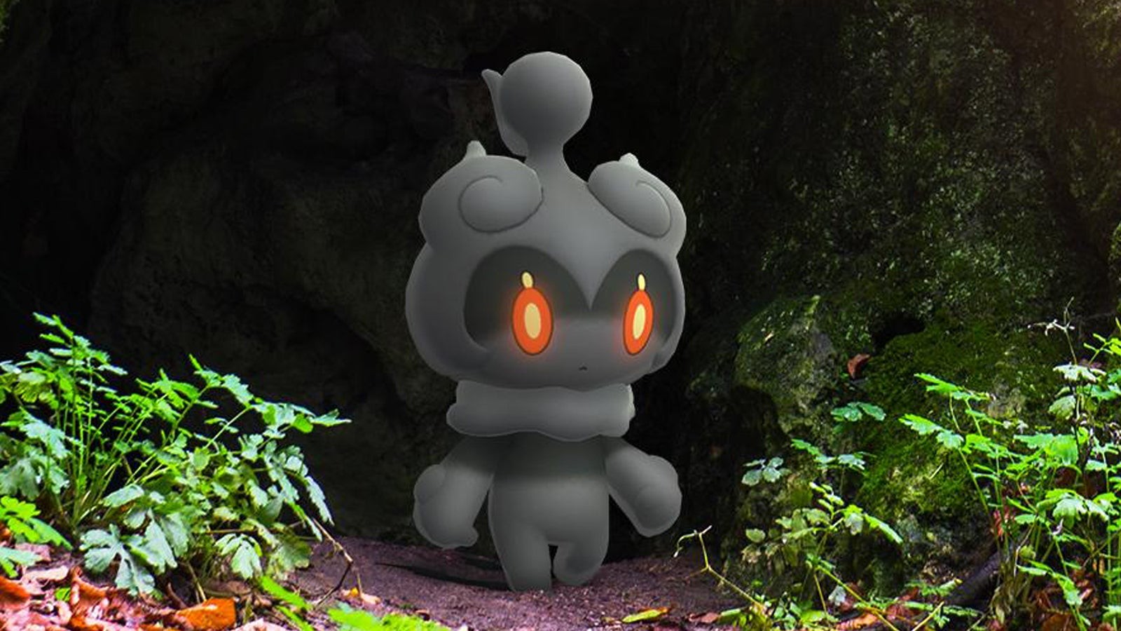 Pokémon Huyền Thoại Marshadow với đôi mắt đỏ rực nhìn ra từ một hang động tối tăm